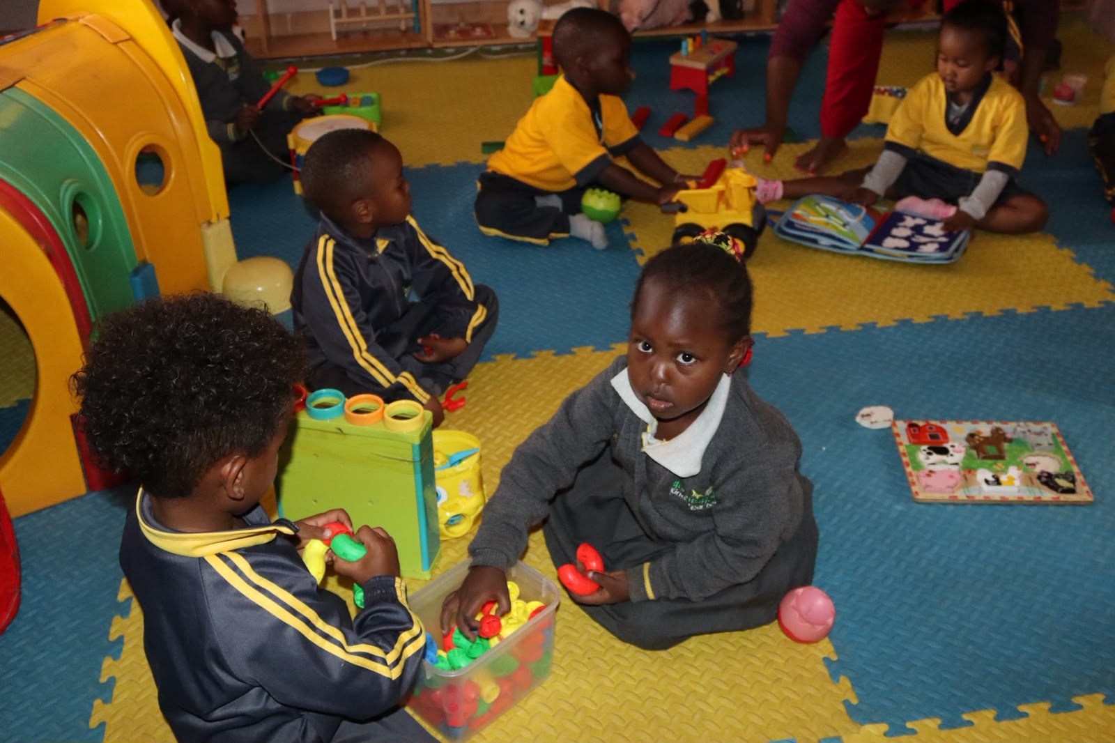 Young children playing outdoors at Bloomsfield School